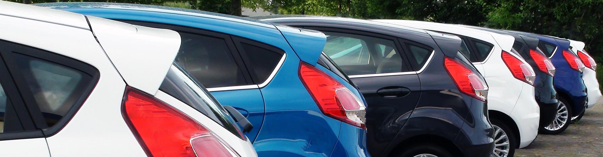 A row of different coloured cars