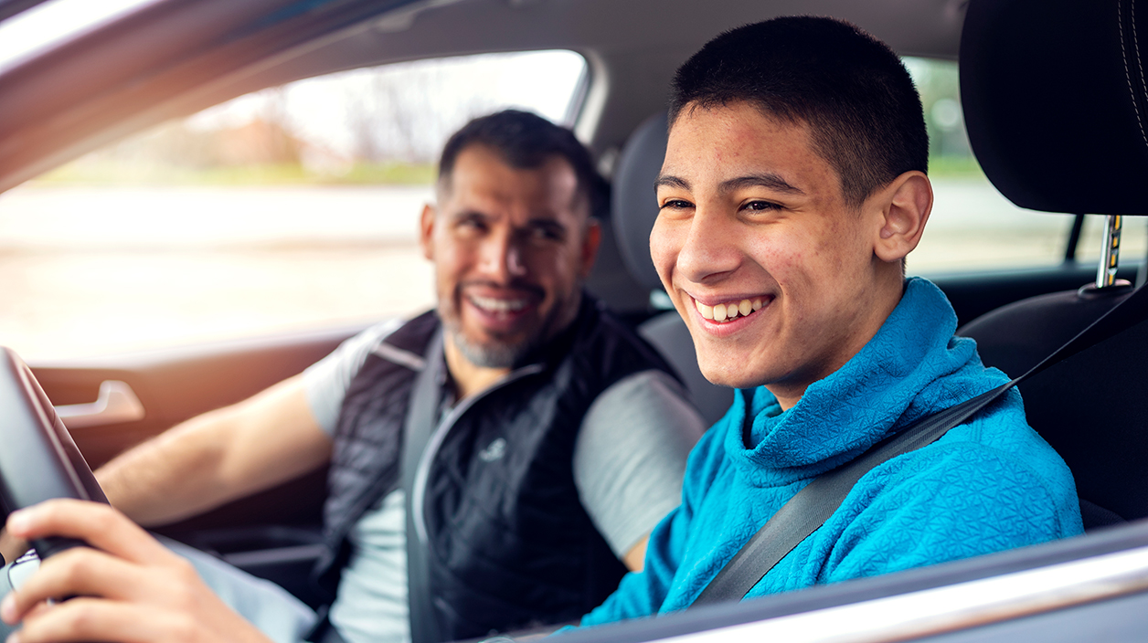 man driving with teenage boy