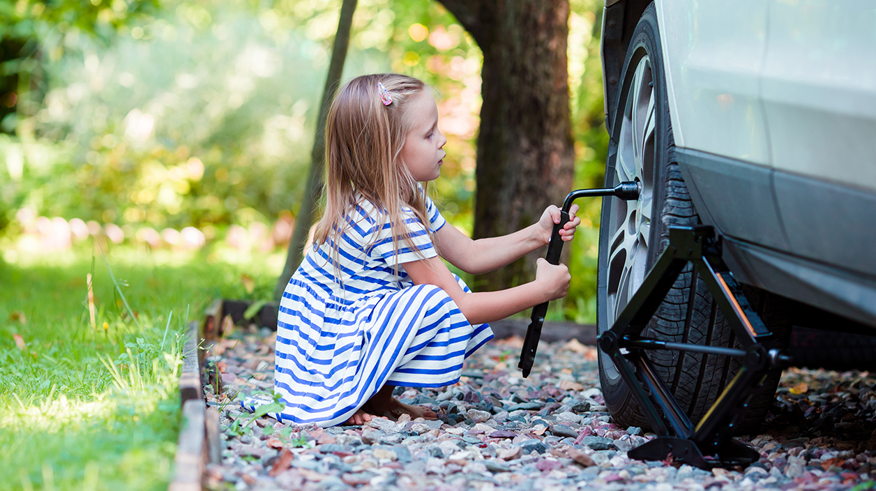 young girl changing tyre