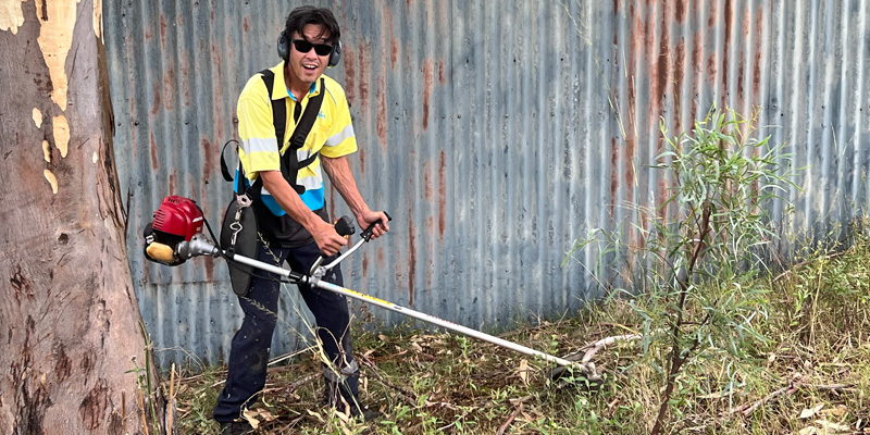 nrma volunteer cutting the grass