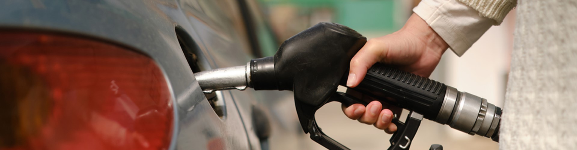 car-being-fueled-1920x500 A grey car being fueled at a gas station.