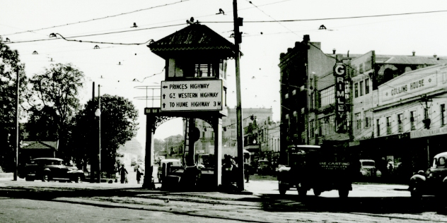 historic black and white image of traffic direction sign on Parramatta road intersection 1952