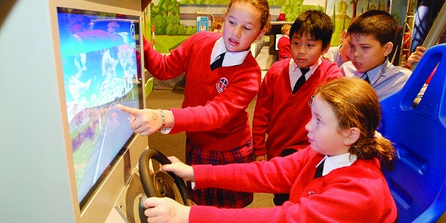 school children using the NRMA RoadZone interactive safety exhibition