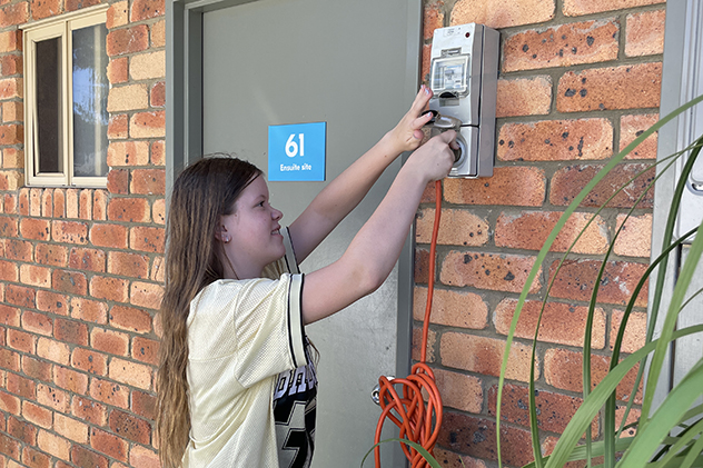 Girl plugging into a power point