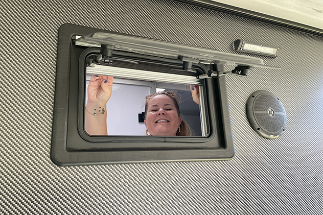 Smiling woman in caravan window