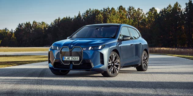 A blue BMW iX parked on a forecourt