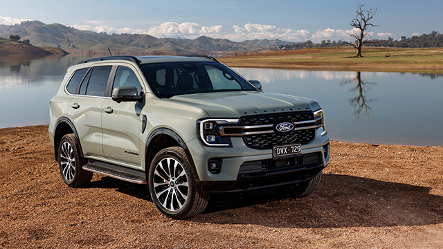 Green Ford Everest Platinum parked near a lake