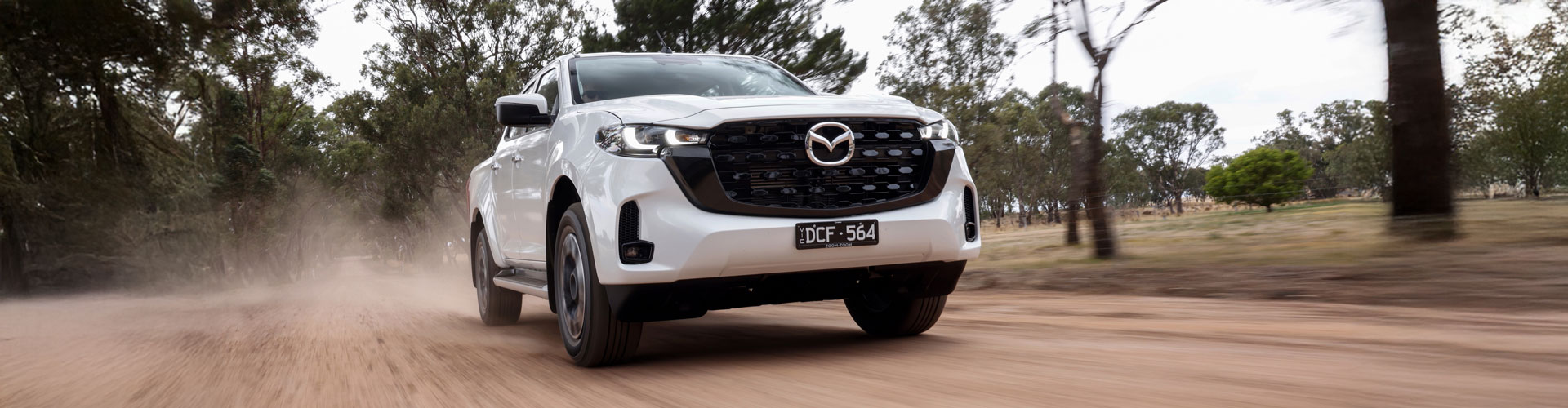 A white Mazda BT-50 on a dirt road