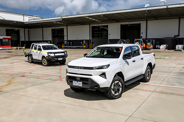 Two Toyota HiLux BEVs in a factory yard