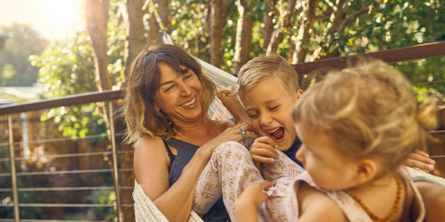 A woman and two kids in a hammock