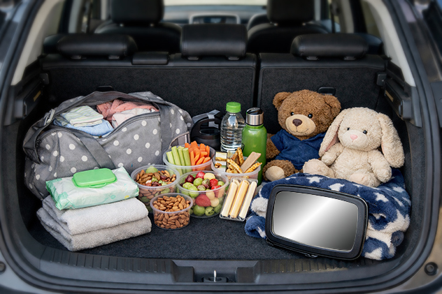 car boot packed with essentials for a road trip for a young family