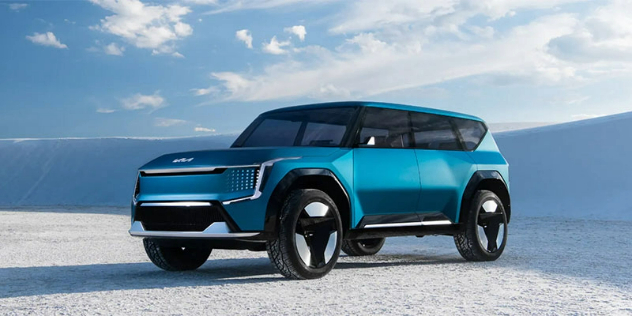 Side-angle view of a Kia EV 9 parked in white snowy terrain.