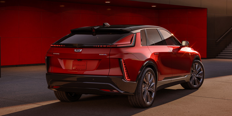 A red 2024 Cadillac Lyric parked in the setting sun