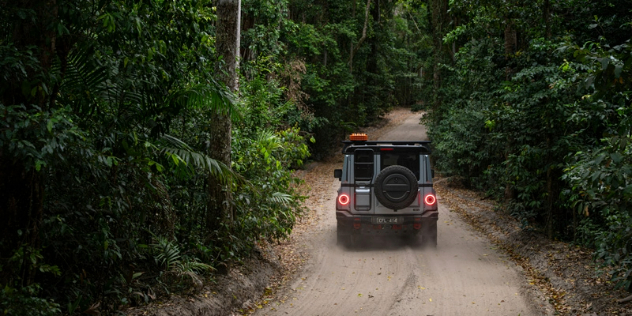 2024 Ineos Grenadier driving through trees