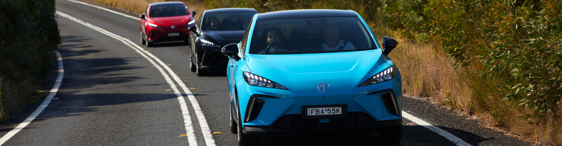 Three MG MG4s on the road