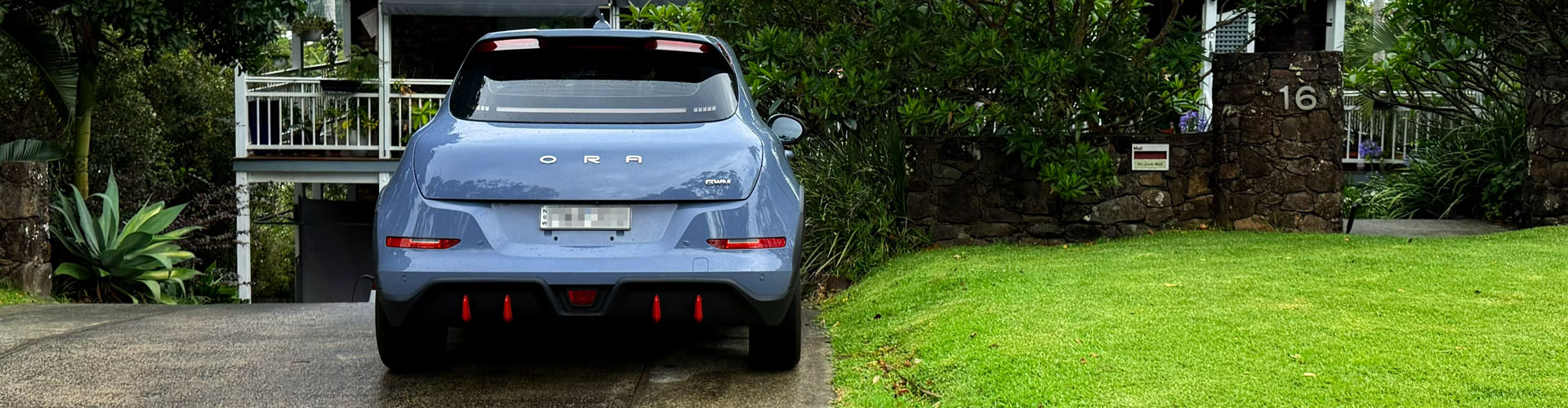A grey car parked in a driveway