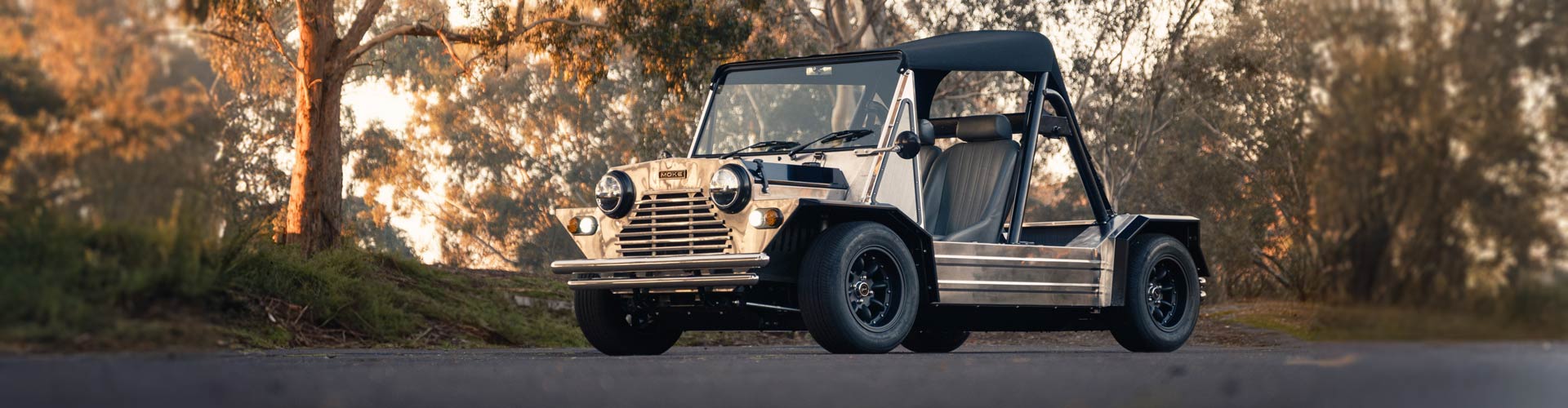 A silver mini moke in the afternoon sun