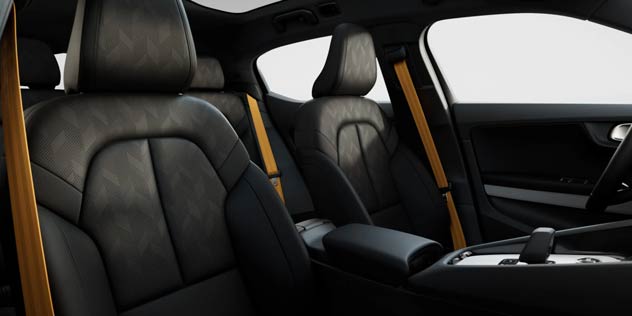 Interior of a Polestar 2 with yellow seat belts