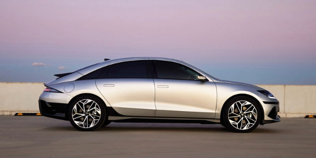 A silver 2024 Hyundai IONIQ 6 parked at dusk