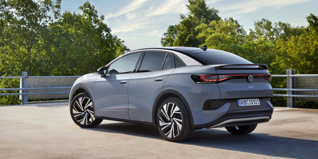 A gray 2024 Volkswagen ID.5 parked on a rooftop carpark with trees in the background