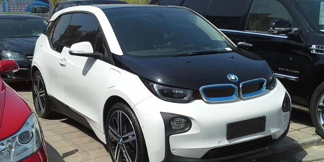 A BMW i5 EV sits in a dealership