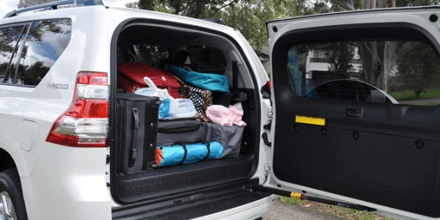 Rear view of a Toyota LandCruiser Prado with an open boot