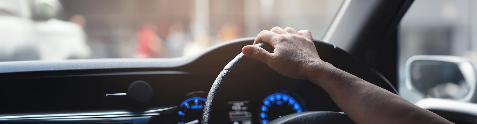 A hand on a steering wheel