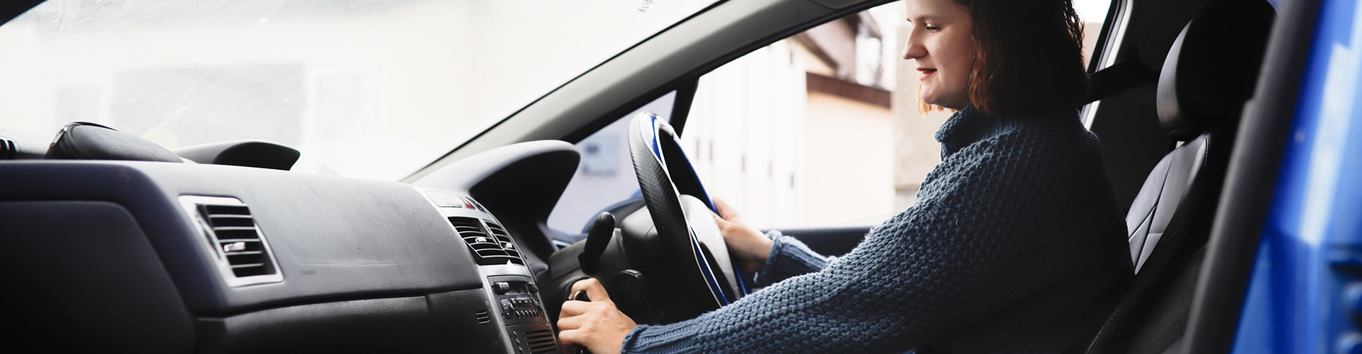 Woman starting a car