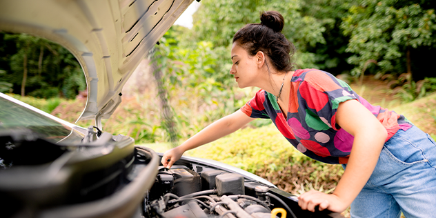 A woman checking her car battery