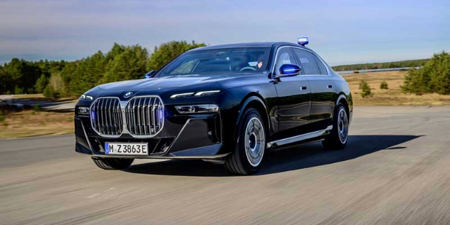 A black BMW i7 xDrive60 on a country road