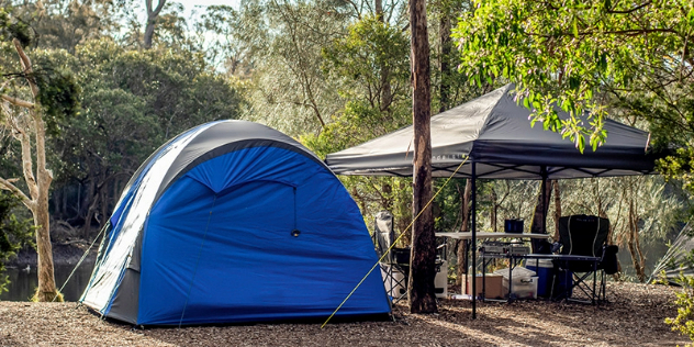 A tent and gazebo set up in a forested area