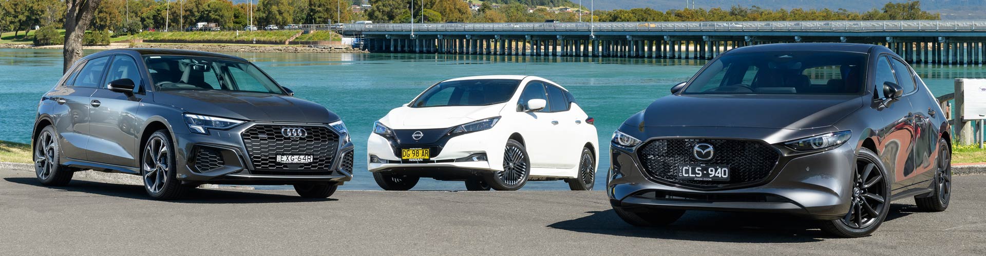 Audi A3 vs Mazda3 vs Nissan Leaf e next to river