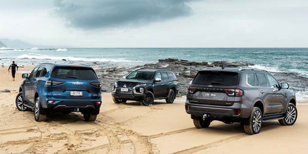 Ford Everest Rugged vs Isuzu MU-X vs Mitsubishi Pajero from rear on beach