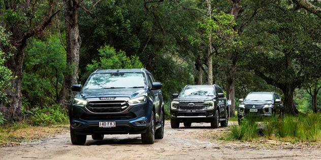 Ford Everest Rugged and Isuzu MU-X and Mitsubishi Pajero driving on road in bush