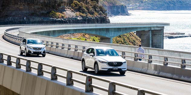 Mazda CX-5 Maxx Sport and Peugeot 3008 Active on the sea cliff bridge