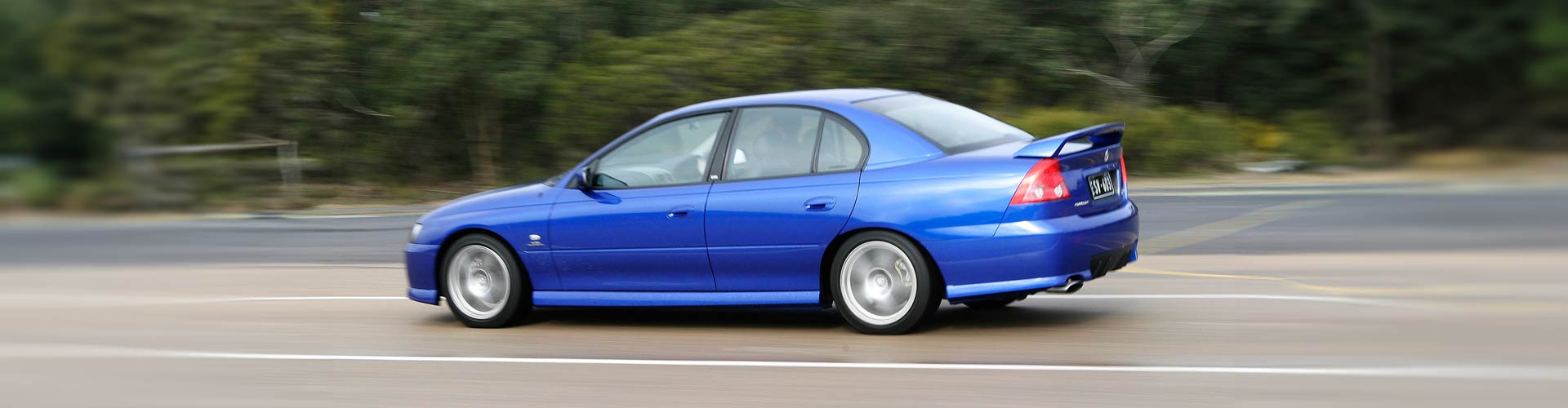 Blue 2005 Holden Commodore VZ SV6 driving on a road