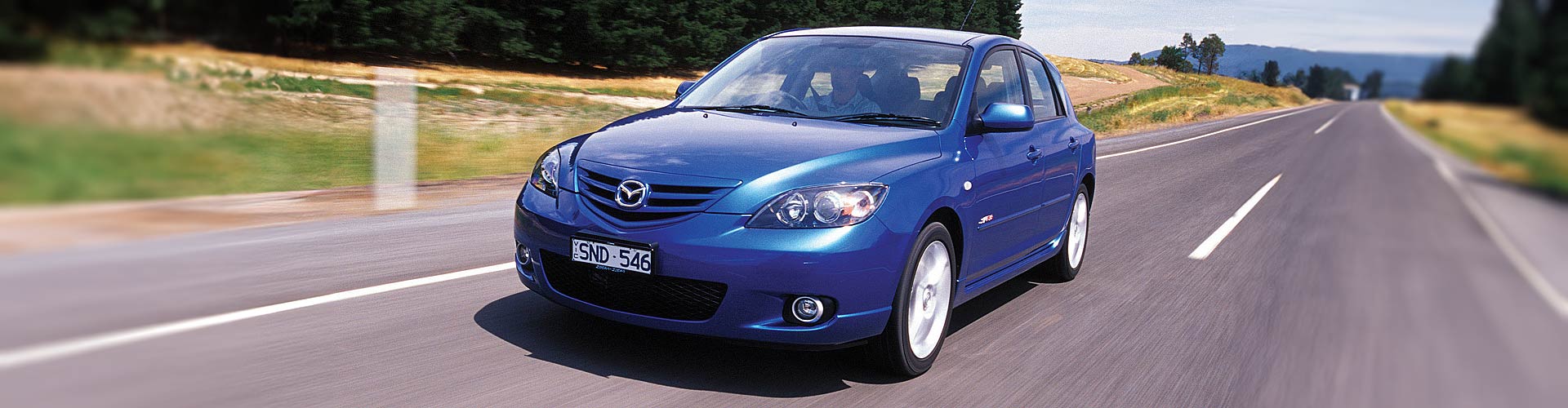 2004 Mazda 3 SP23 driving on a country road