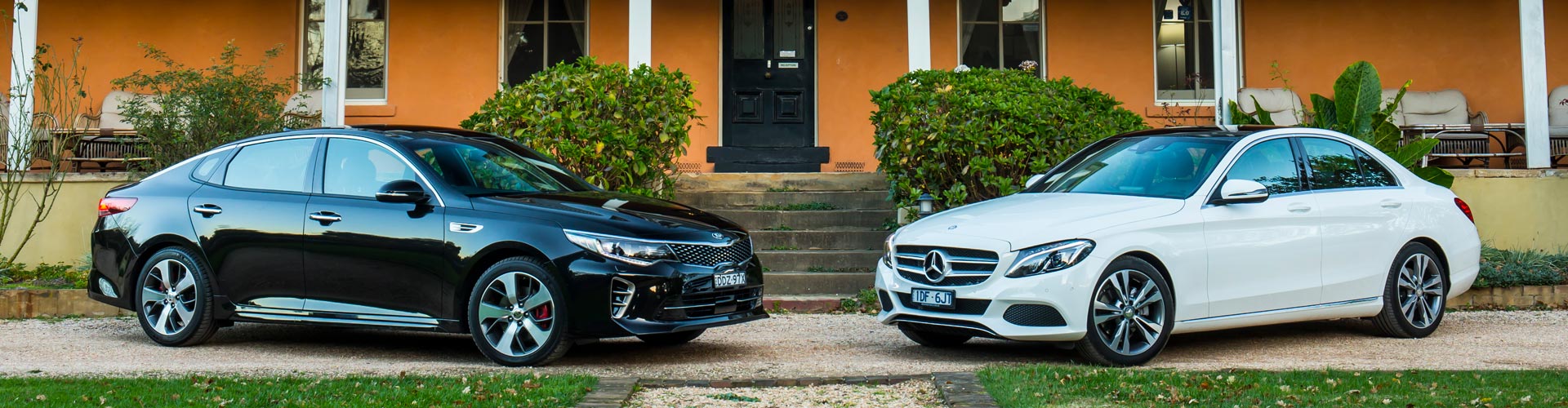 2016 Mercedes Benz C200 and Kia Optima GT parked outside an orange house