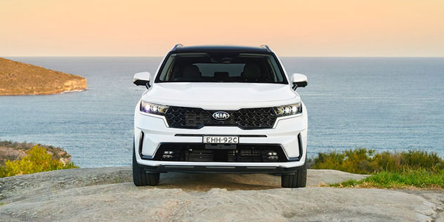 White 2020 Kia Sorento parked on a rock in front of the ocean