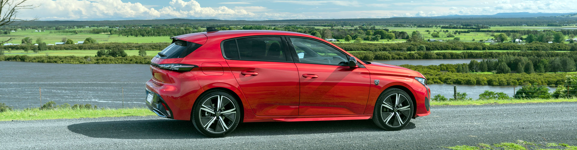 Side on view of a red 2023 Peugeot 308