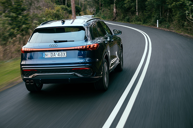 Rear view of 2025 Audi Q5 TDI driving on the road