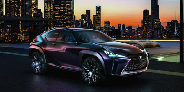 Side angle view of a Lexus parked on a rooftop with a cityscape in the background.