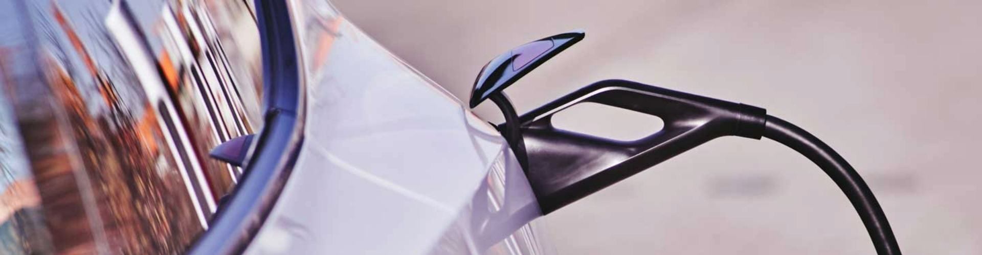 Side view of an EV charging cable plugged into a car. Photo: Michael Fortsch.