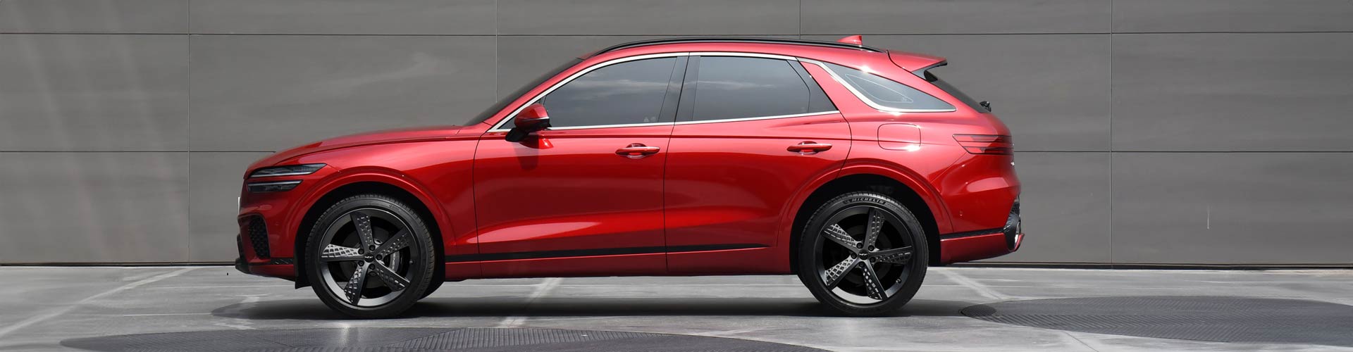 Red 2021 Genesis GV70 parked on marble floor