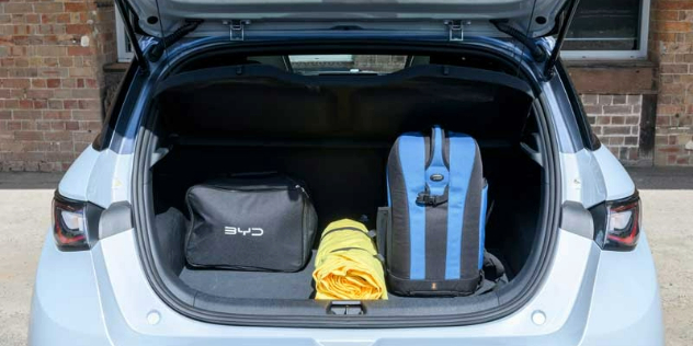 An open car boot with two bags in it.