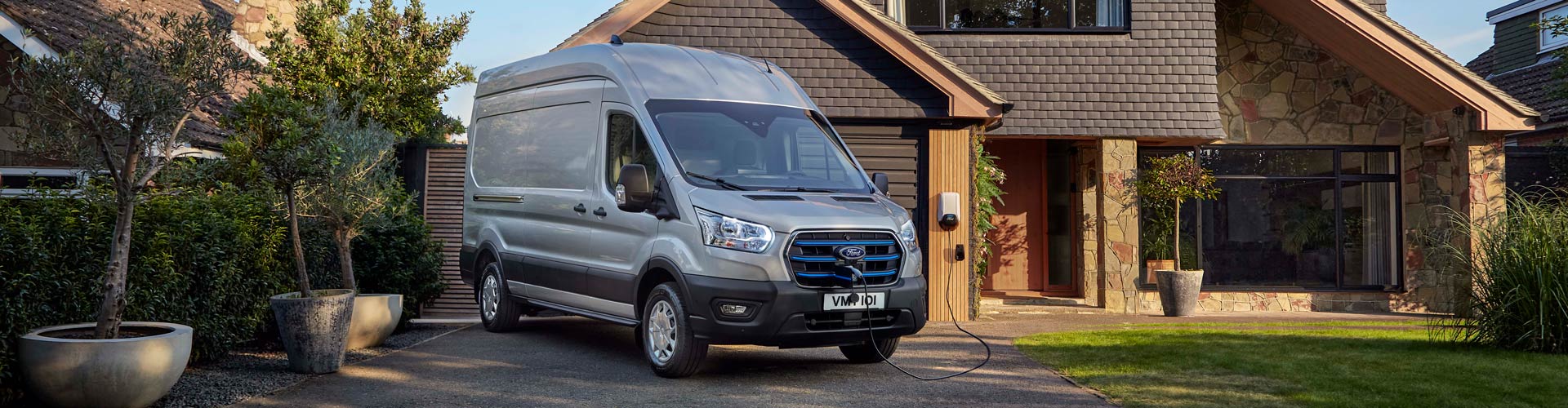 Electric Ford van charging outside a house