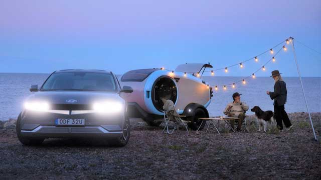 A family camping with their Hyundai Ioniq 5 powering fairy lights