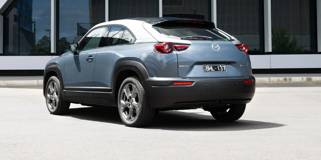 Rear-angle view of a grey Mazda MX-30 Electric.