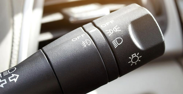 Close-up view of a car's fog light control stick