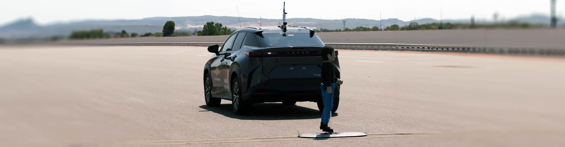 Child-sized dummy placed behind rear of Lexus RZ in safety test